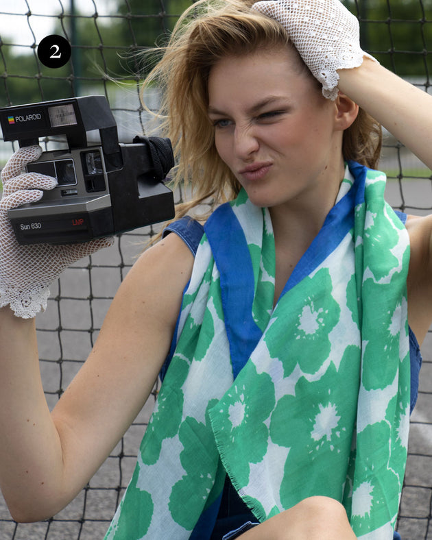 Woman wearing floral print scarf in green