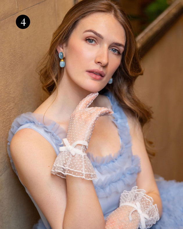 Woman wearing spotty tulle gloves with frilled cuffs in ivory