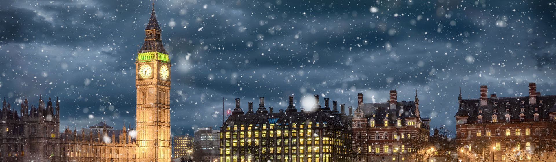Winter Sale Graphic - Big Ben tower illuminated at night with snow falling in London