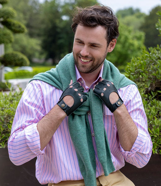 Man wearing fingerless leather driving gloves in lincoln green