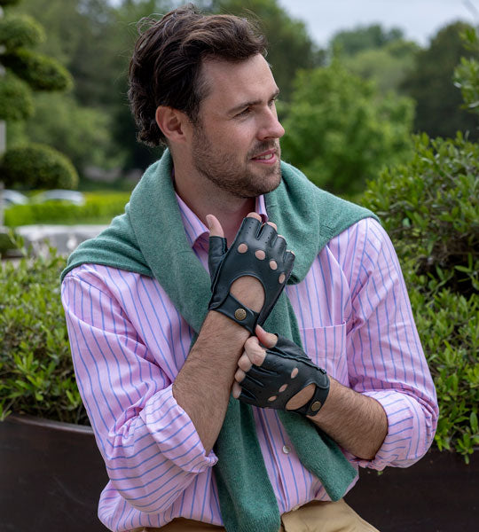 Man wearing leather fingerless driving gloves in british racing green 