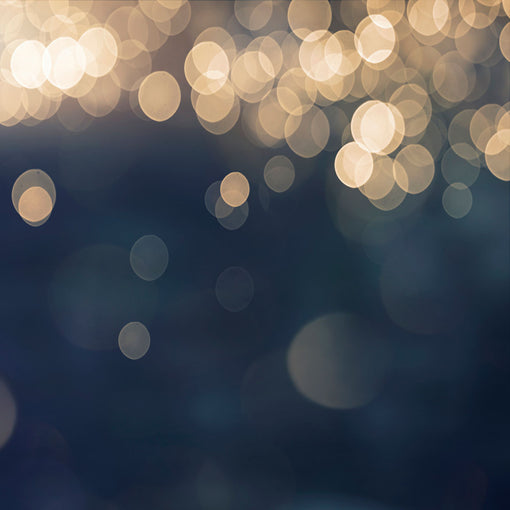 Gold twinkly lights against a navy blue background