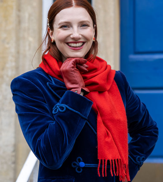 Woman wearing plain cashmere in red outdoors