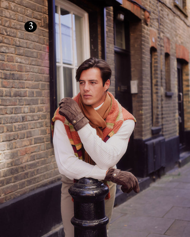 Man wearing three point fleece lined suede gloves in brown